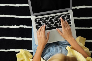 Photo of Woman working with laptop at home, closeup view