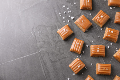 Photo of Salted caramel on grey table, flat lay. Space for text