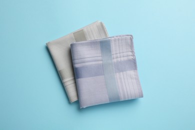 Stylish handkerchiefs on light blue background, flat lay