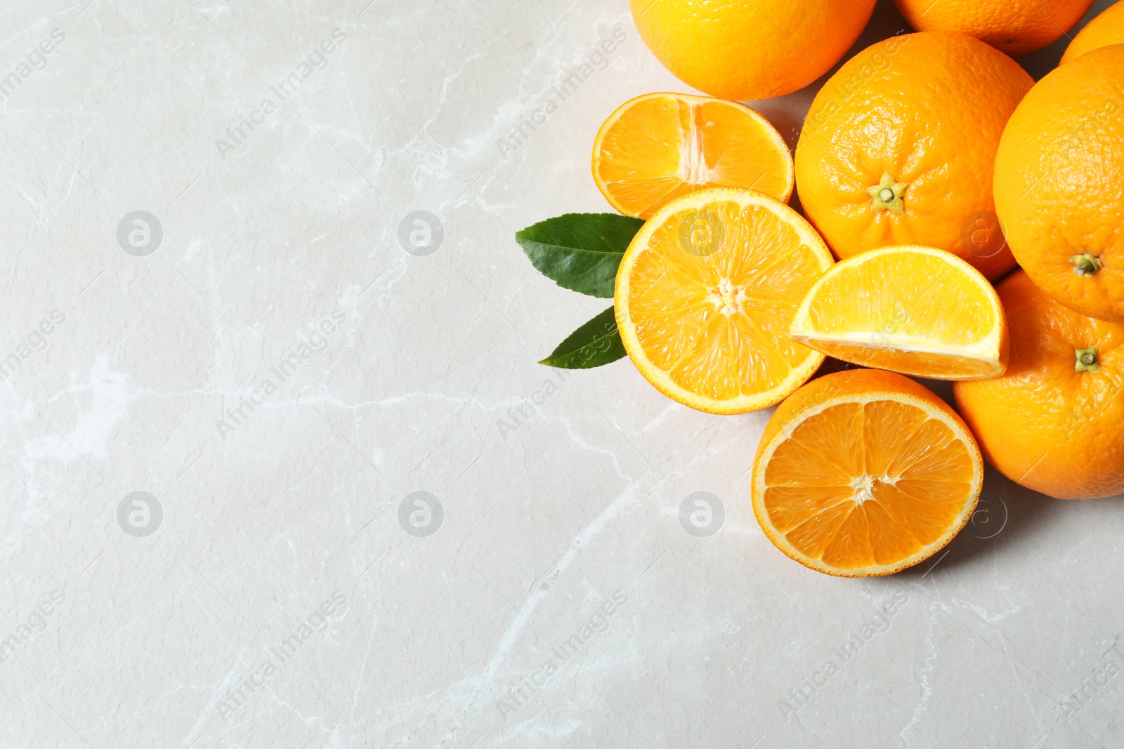 Photo of Flat lay composition with ripe oranges and space for text on light background