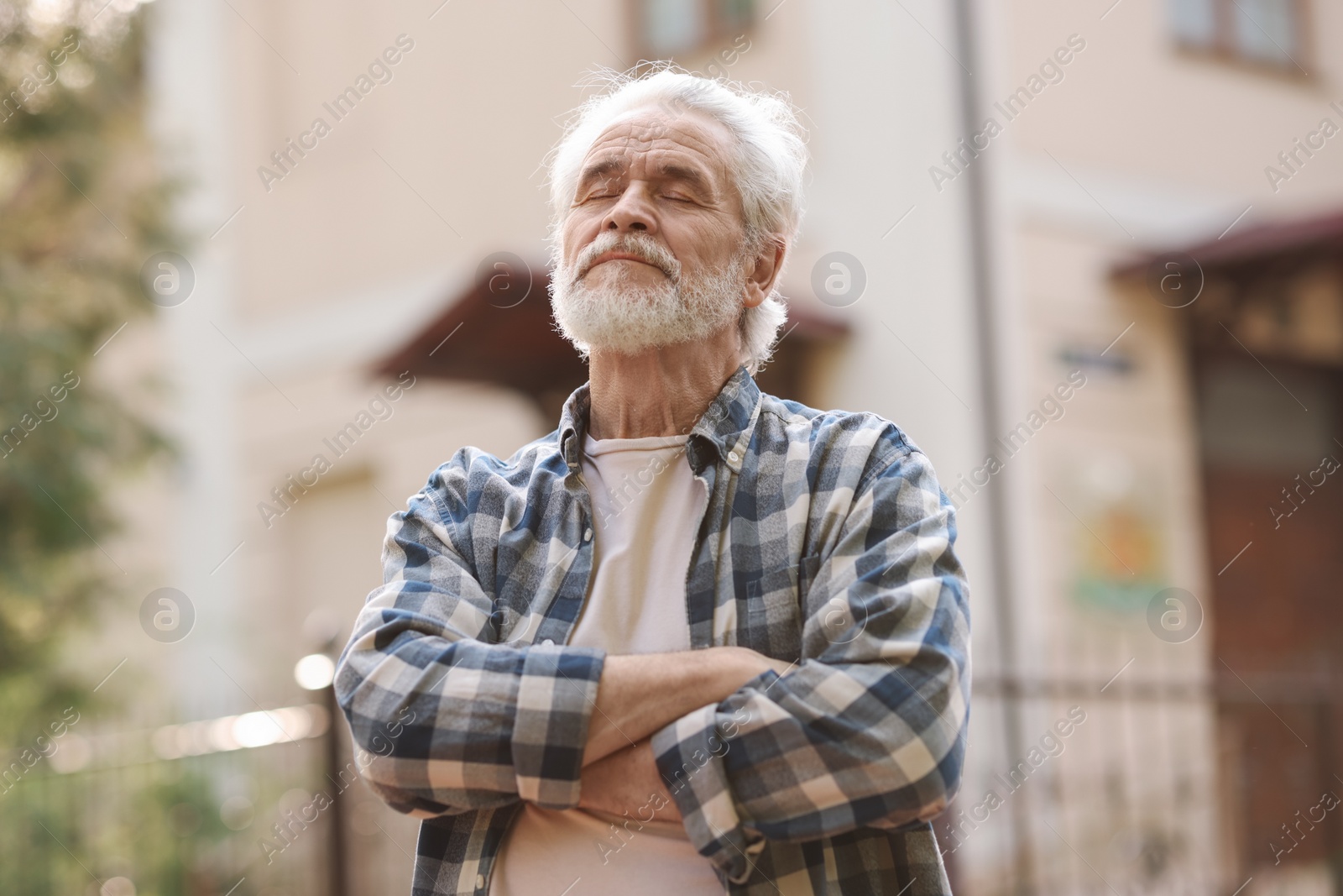 Photo of Portrait of happy grandpa with grey hair outdoors