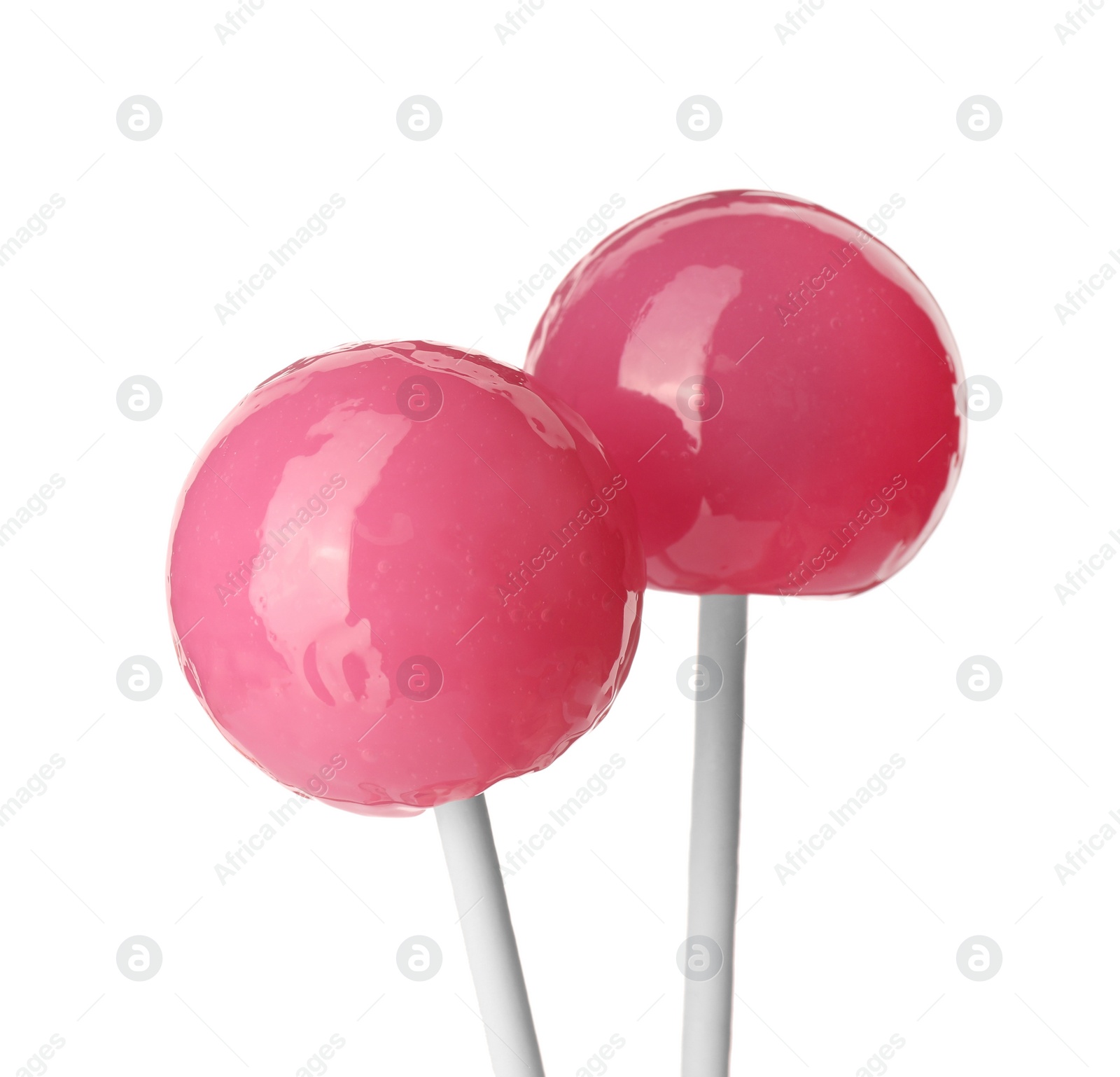 Photo of Tasty pink lollipops isolated on white. Confectionery product