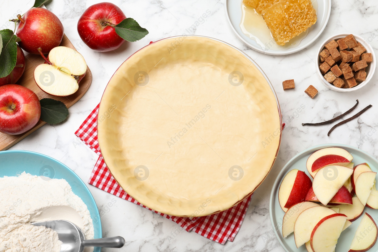 Photo of Flat lay composition with raw dough and ingredients on white marble table. Baking apple pie