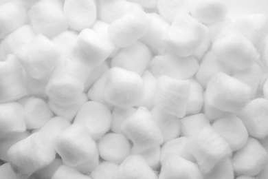 Soft clean cotton balls as background, top view