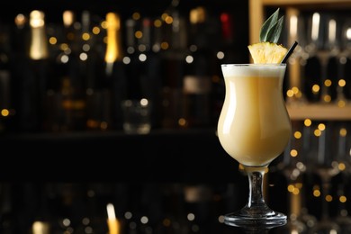 Photo of Tasty Pina Colada cocktail on bar countertop, space for text