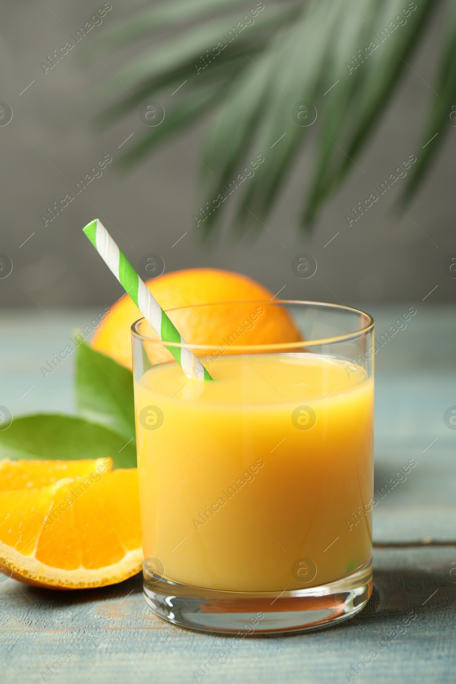 Photo of Glass of orange juice and fresh fruits on wooden table