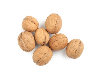 Photo of Whole walnuts in shell on white background, top view