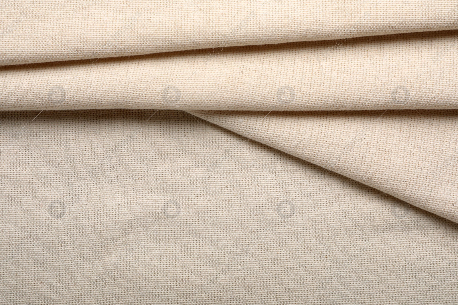 Photo of Beige hemp cloth as background, top view. Natural fabric