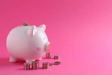 Financial savings. Piggy bank and coins on pink background, space for text