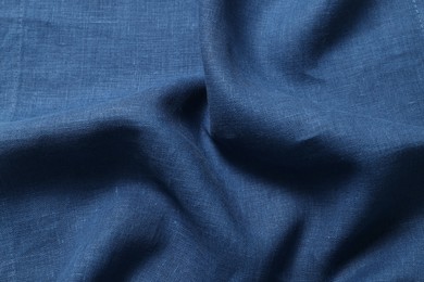Photo of Texture of blue crumpled fabric as background, closeup