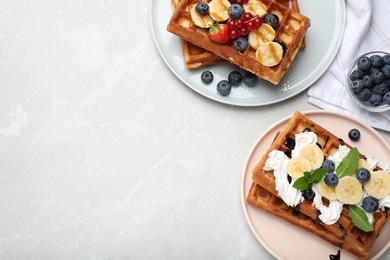 Photo of Delicious Belgian waffles served on light marble table, flat lay. Space for text