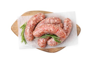 Wooden board with raw homemade sausages and rosemary isolated on white, top view