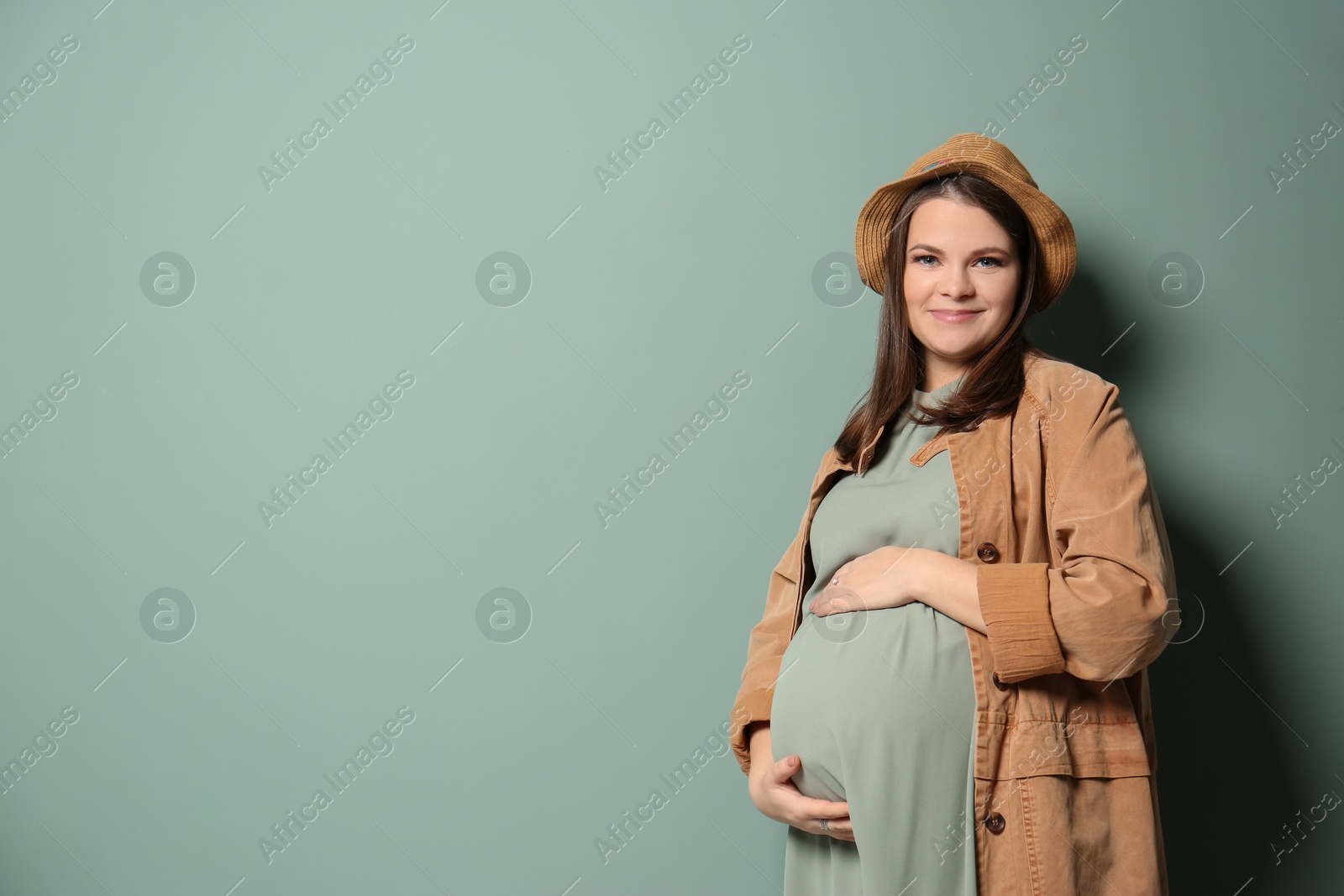 Photo of Beautiful pregnant woman on color background