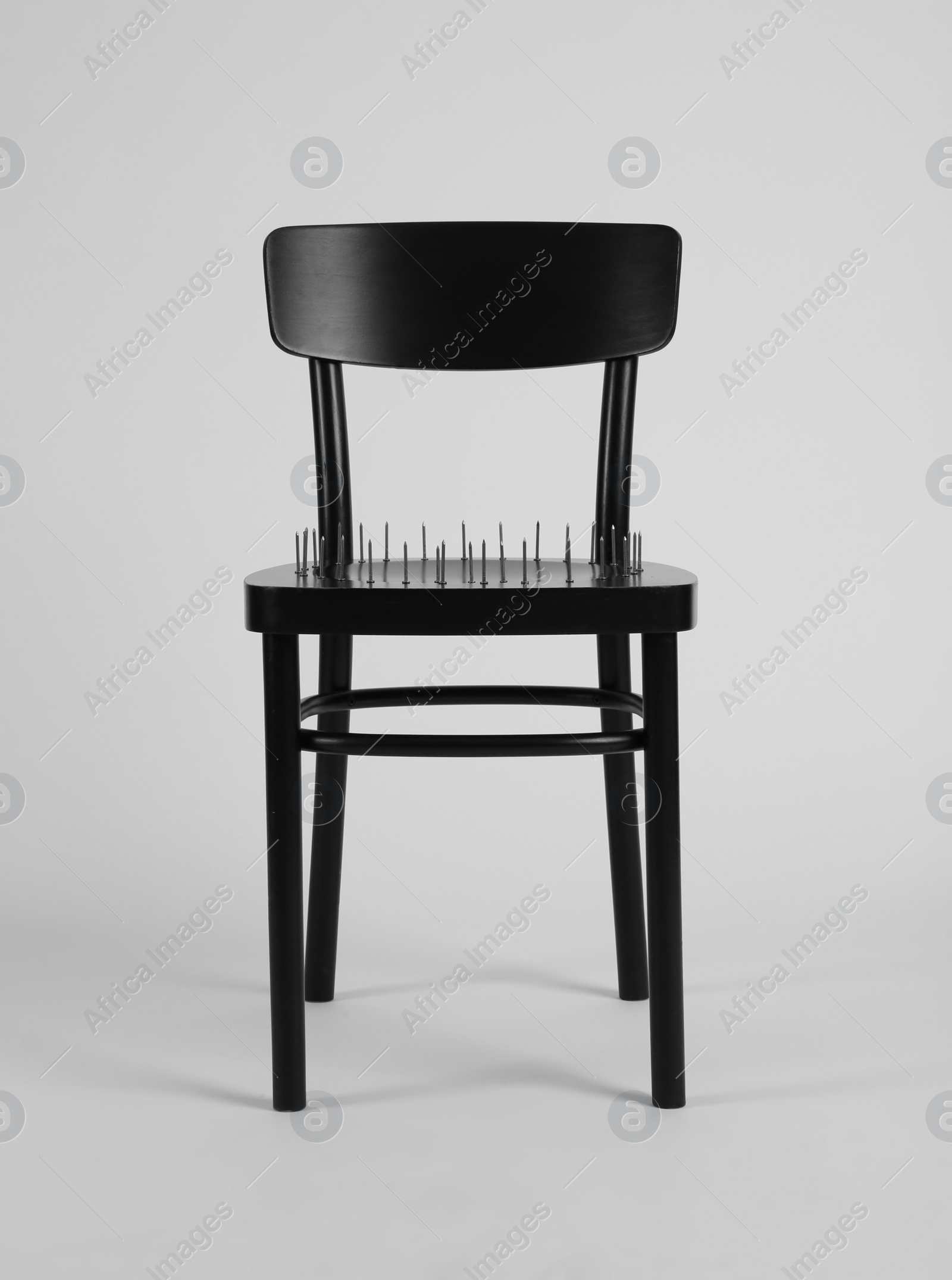 Photo of Chair with iron nails isolated on white. Hemorrhoids concept