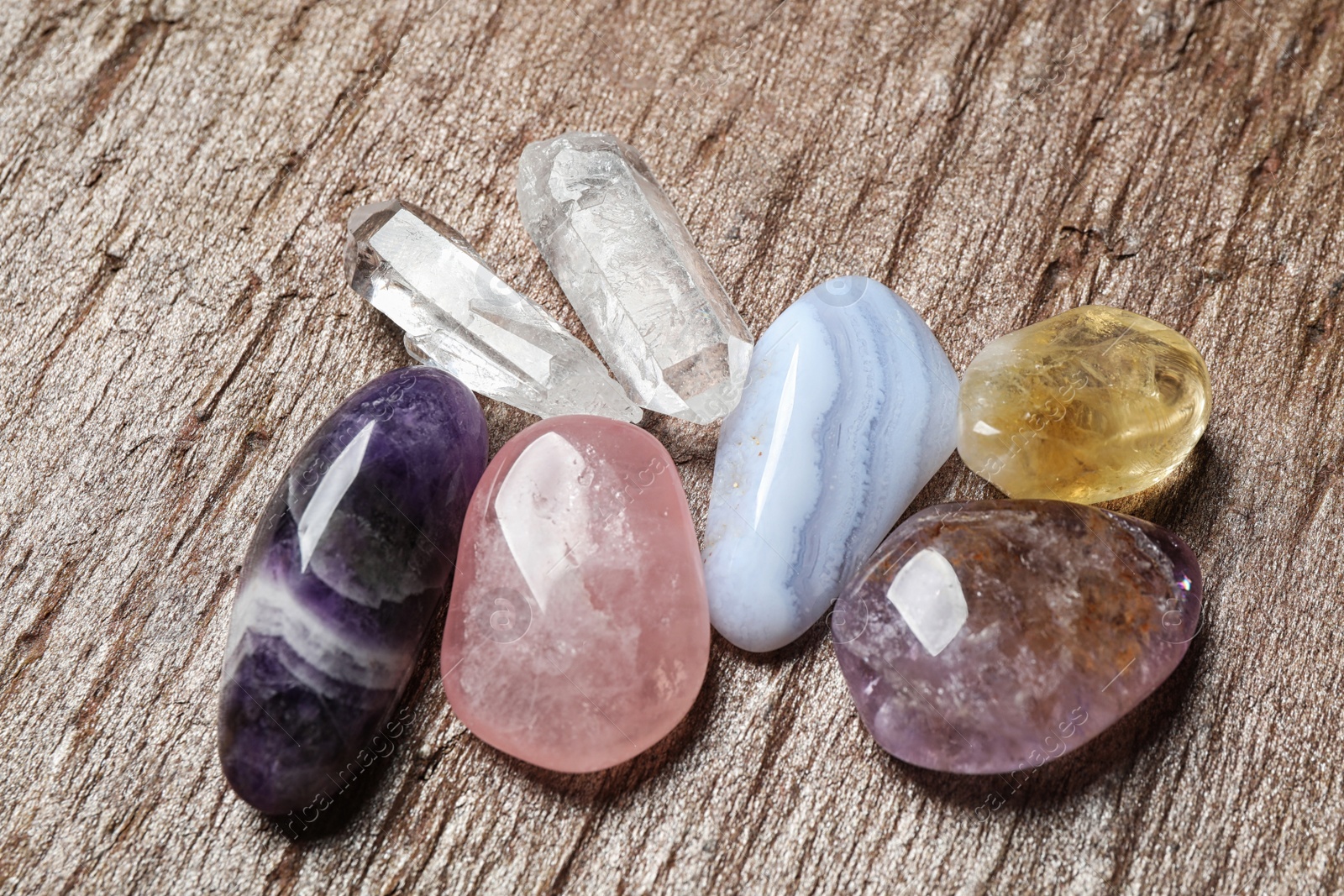 Photo of Different beautiful gemstones on textured brown surface