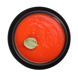 Photo of Delicious tomato cream soup in bowl isolated on white, top view