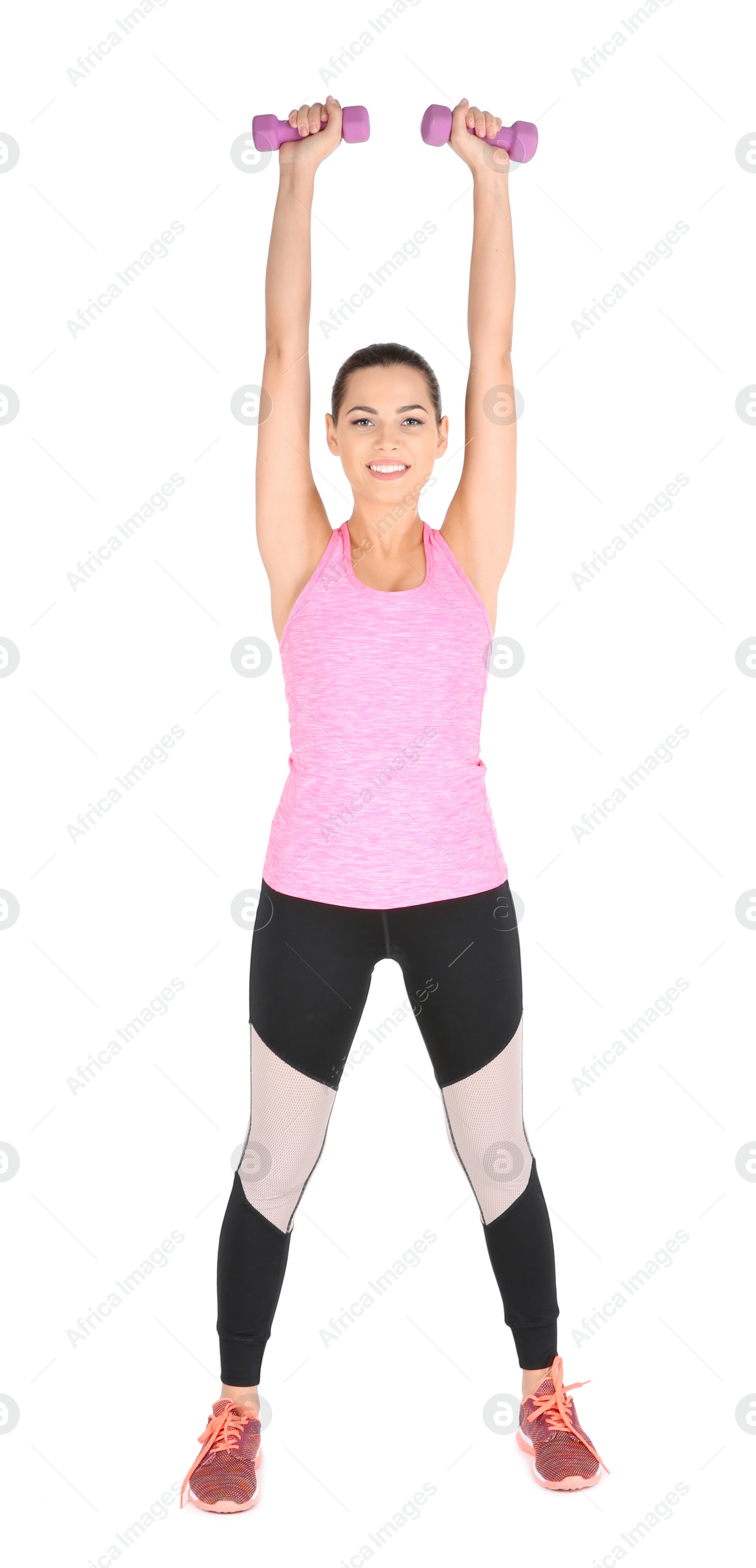 Photo of Young beautiful woman with dumbbells doing exercise on white background. Home fitness