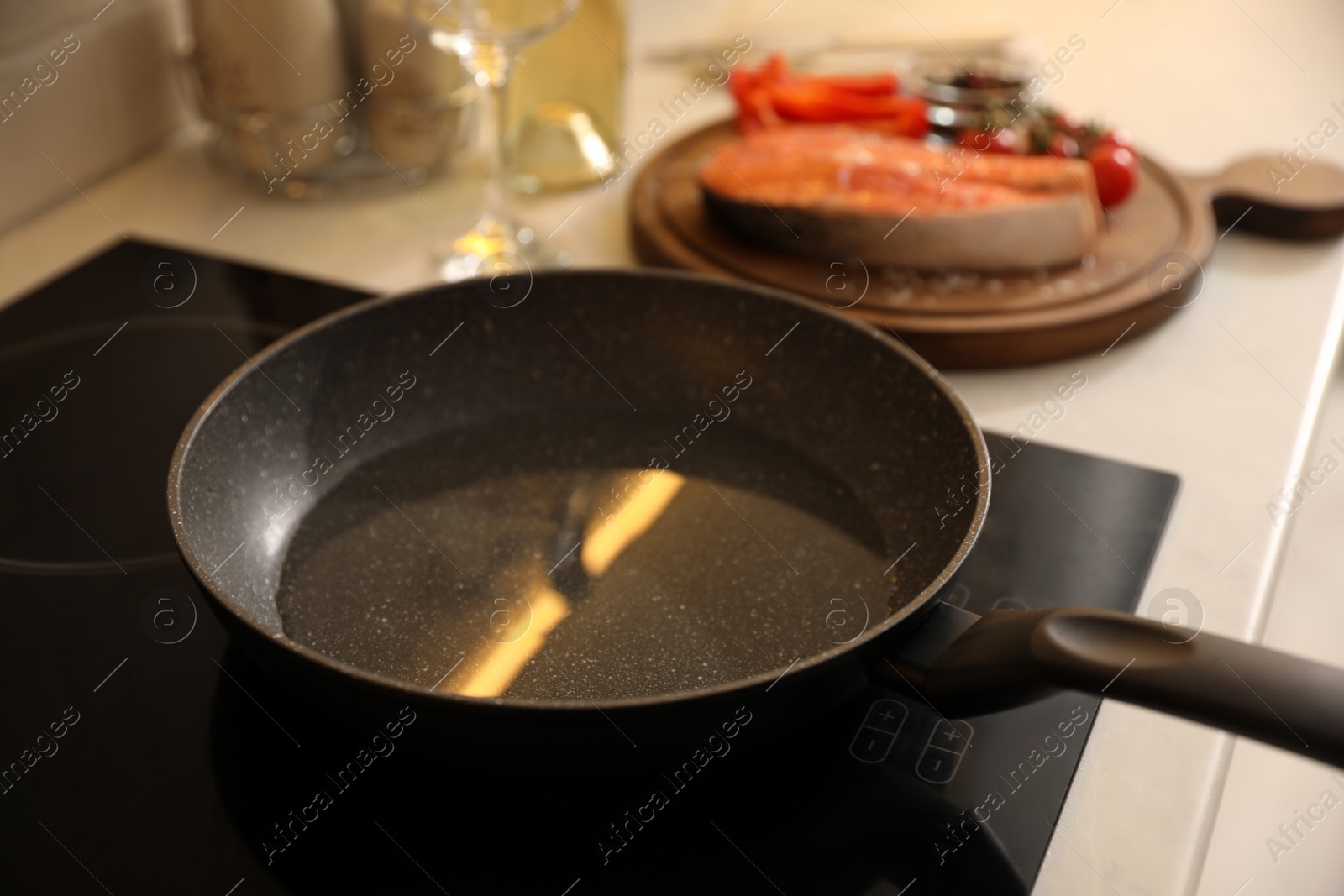 Photo of Frying pan with cooking oil on cooktop