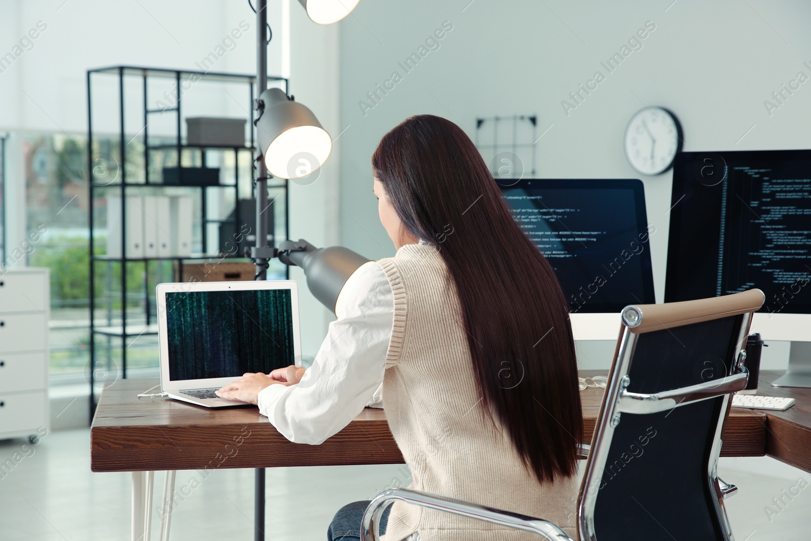 Photo of Programmer working at desk in modern office