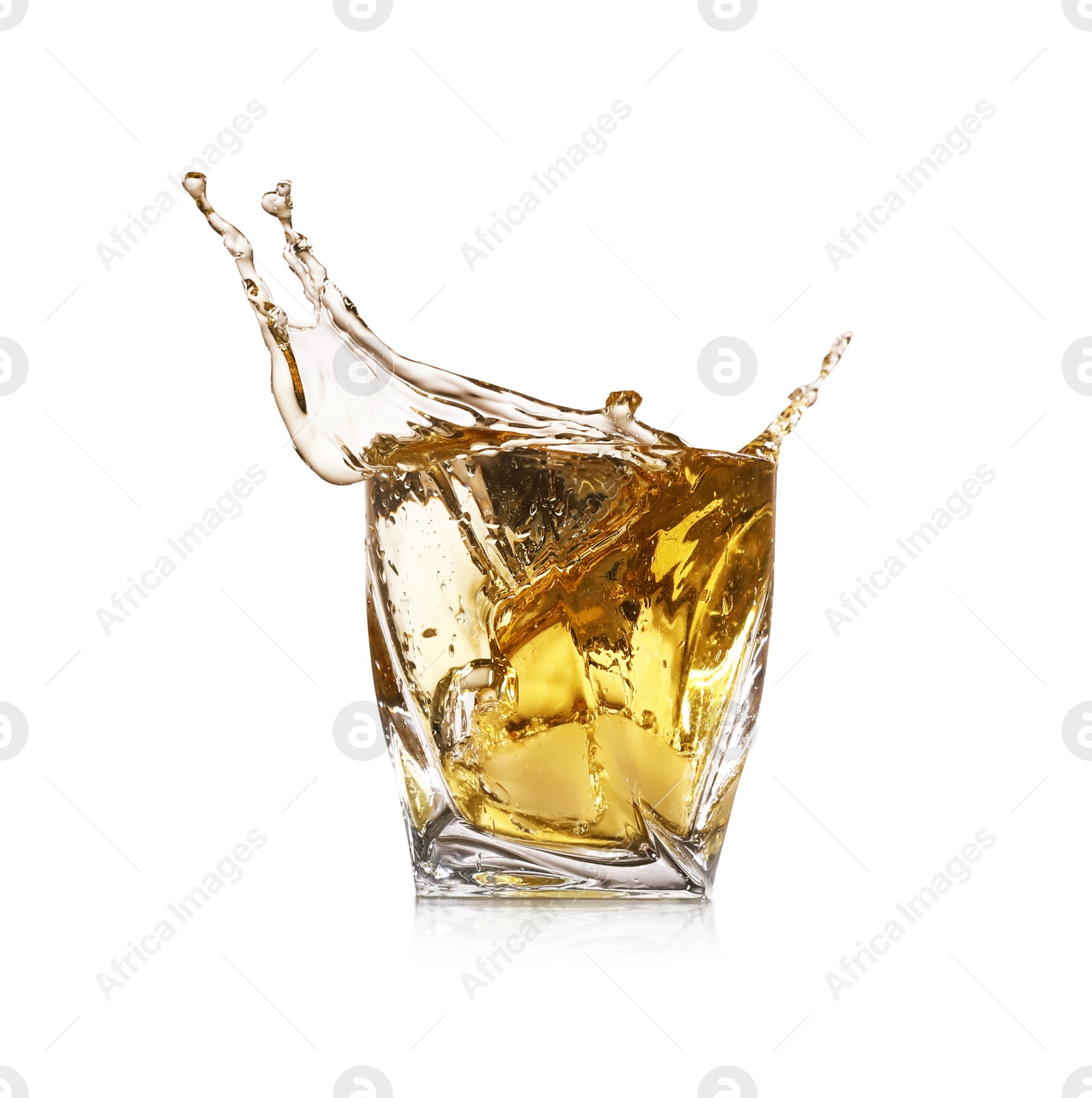 Photo of Whiskey splashing in glass on white background