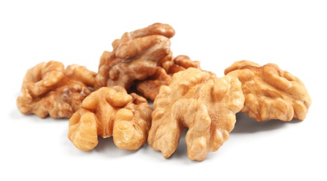 Photo of Pile of peeled walnuts on white background
