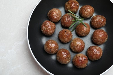 Photo of Tasty cooked meatballs on light grey marble table, top view