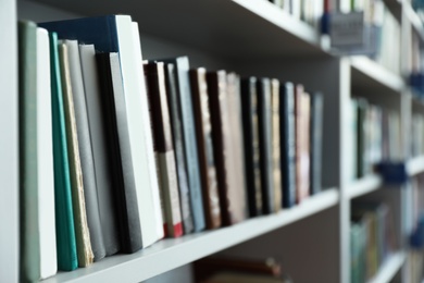 Photo of Closeup view of shelves with books in library