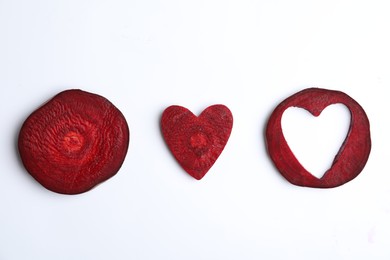 Composition with cut raw beets on white background, top view