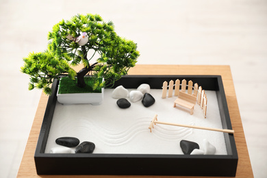Photo of Beautiful miniature zen garden on wooden table
