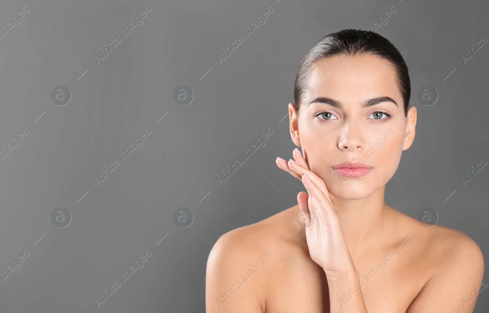 Photo of Portrait of beautiful young woman and space for text on grey background. Cosmetic surgery concept