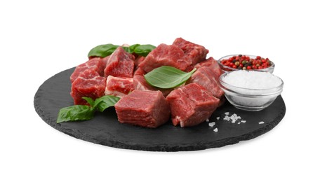 Photo of Slate plate with cut fresh beef meat, basil leaves and spices isolated on white