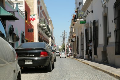 Photo of MONTERREY (NUEVO LEON), MEXICO - SEPTEMBER 29, 2022: Beautiful view of city street with parked cars on sunny day
