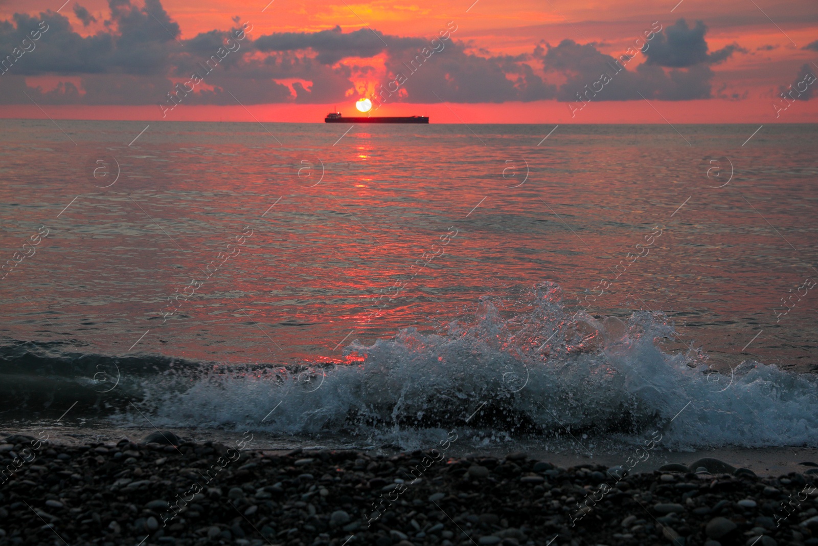 Photo of Picturesque view of sunset with clouds over sea