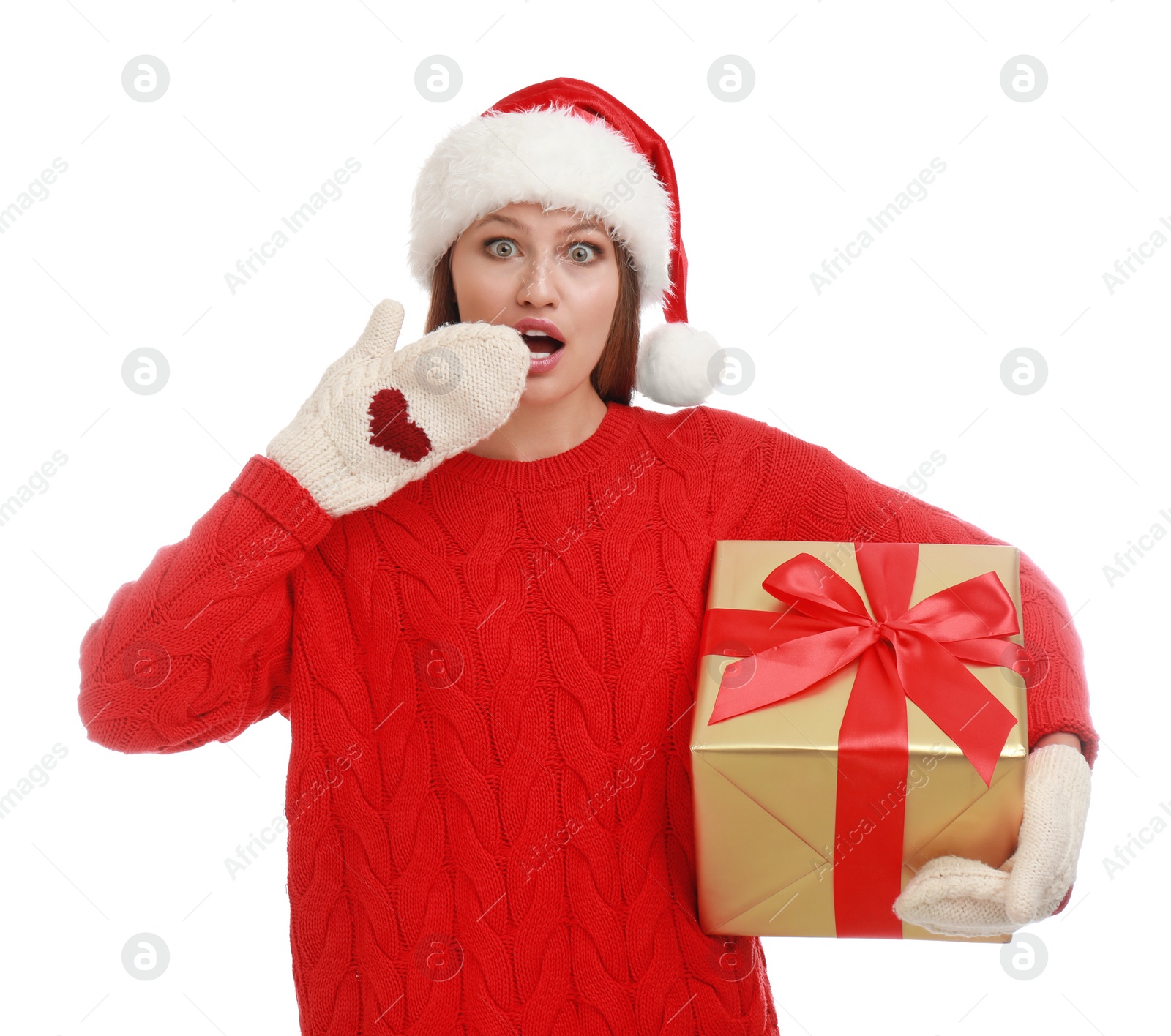 Photo of Emotional young woman in Santa hat with Christmas gift on white background