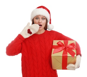 Photo of Emotional young woman in Santa hat with Christmas gift on white background