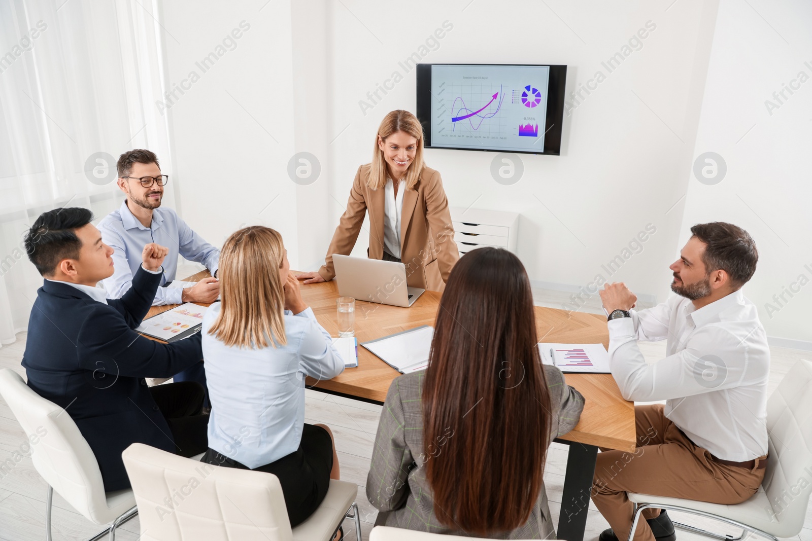 Photo of Businesswoman having meeting with her employees in office