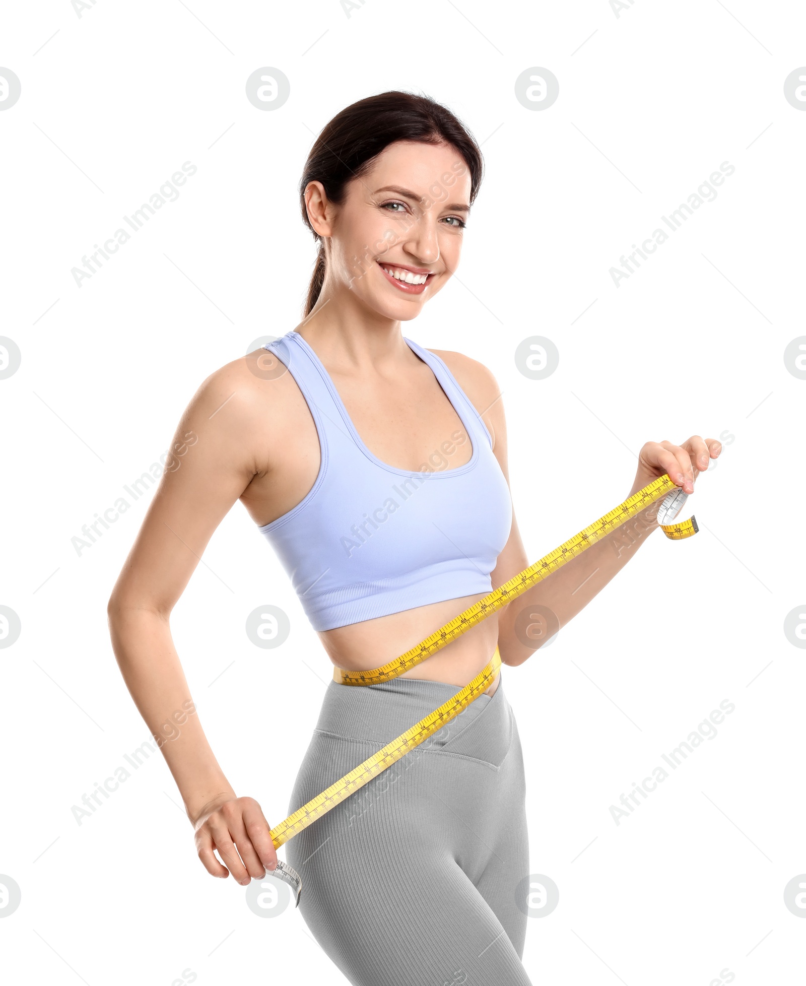 Photo of Happy young woman with measuring tape showing her slim body against white background