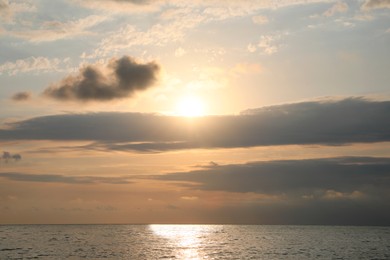 Picturesque view of sunset with beautiful clouds over sea