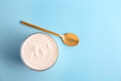 Photo of Glass with tasty yogurt on color background, top view