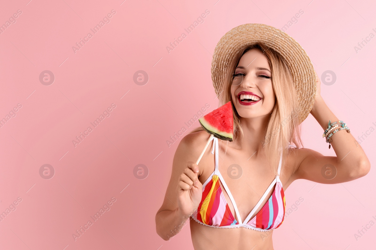 Photo of Pretty young woman with juicy watermelon on color background