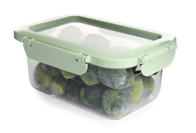 Photo of Frozen Brussels sprouts in plastic container isolated on white. Vegetable preservation