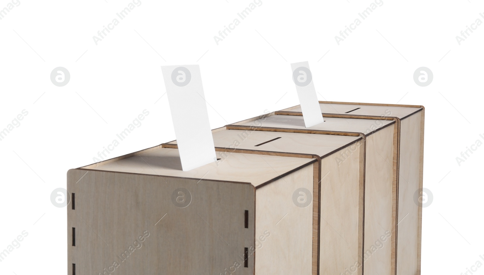 Photo of Wooden ballot boxes with votes isolated on white