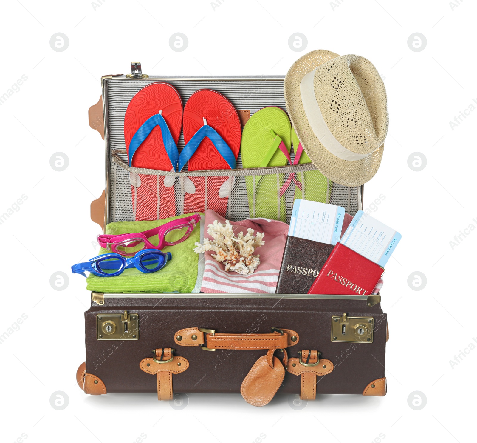 Photo of Open vintage suitcase with different beach objects packed for summer vacation isolated on white