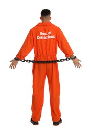 Photo of Prisoner in orange jumpsuit with chained hands on white background, back view