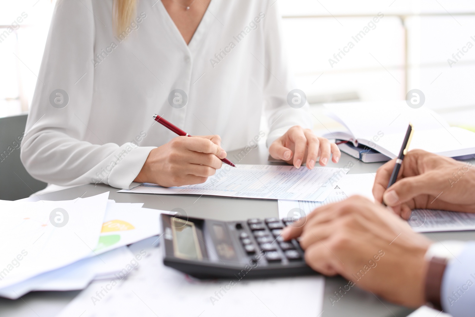 Photo of Tax accountants working with documents at table