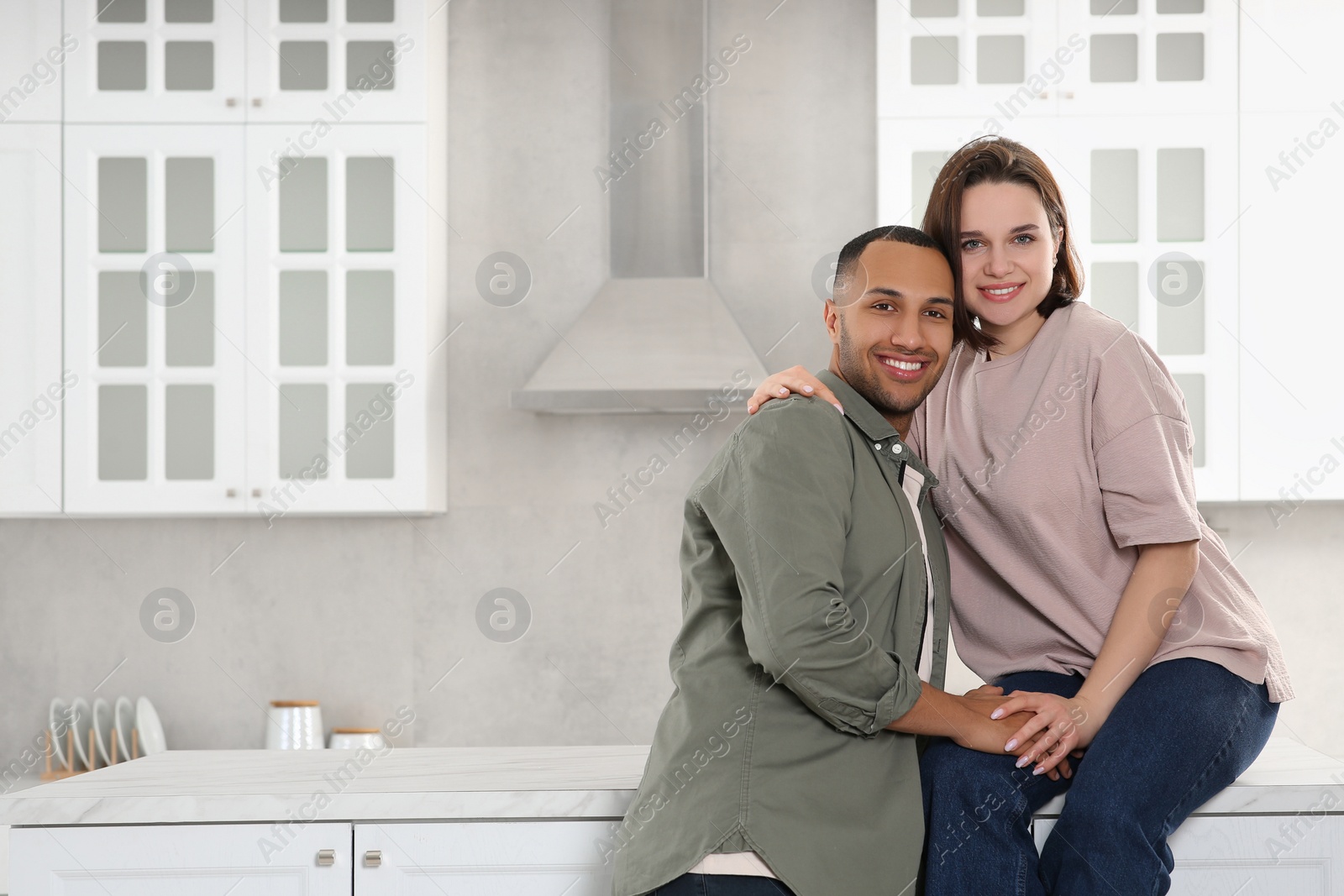 Photo of Dating agency. Happy couple spending time together in kitchen, space for text