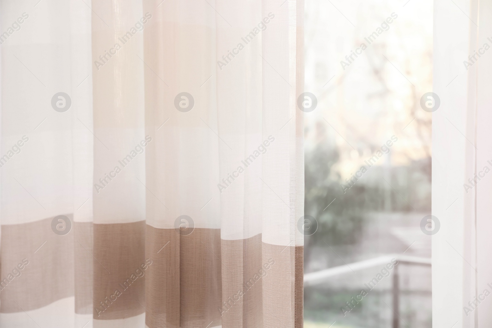 Photo of Window with elegant curtains indoors, closeup view