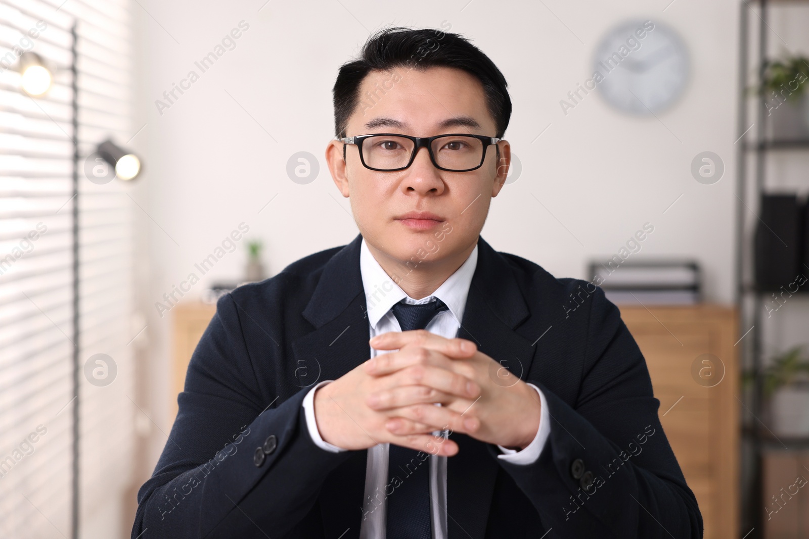 Photo of Portrait of confident notary working in office