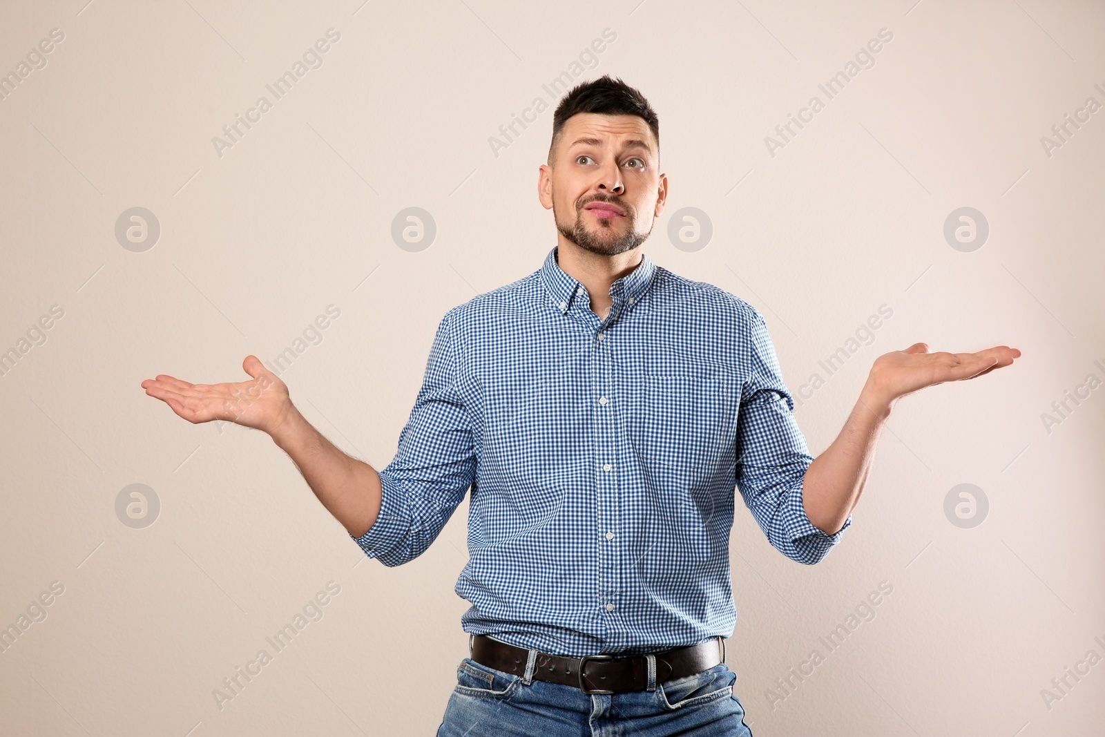Photo of Emotional man in casual outfit on grey background