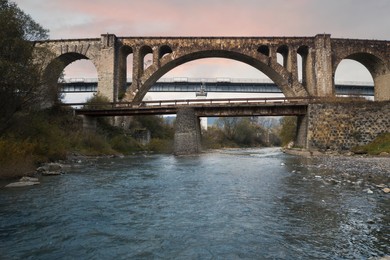 Image of View of bridges over river on autumn day